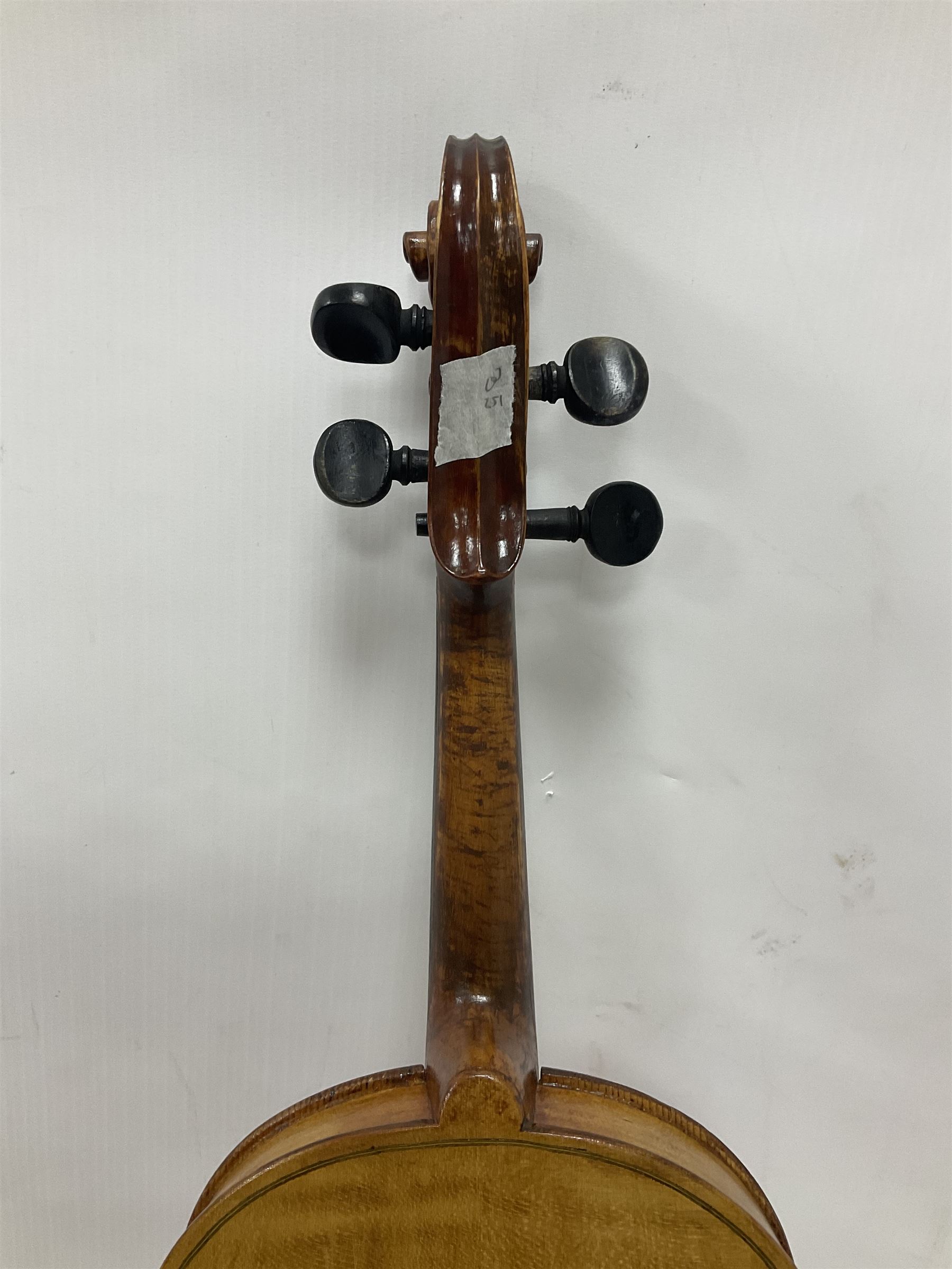Copy of a full size Stradivarius violin, with an ebonised fretboard, tailpiece and tuning pegs, with a polished chin rest  Length 60cm