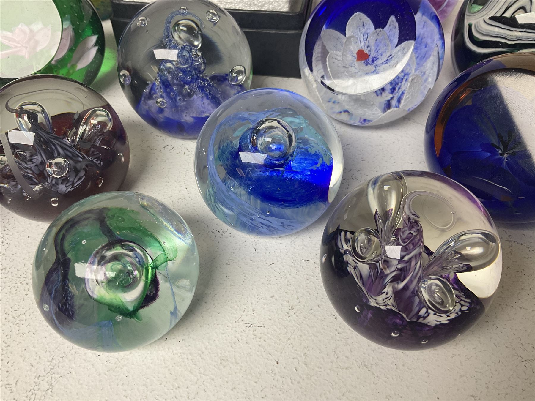 Twelve Caithness glass paperweights, to include Pastel, Mooncrystal and Fiesta, together with Baccarat 'The Princess Anne' paperweight and two Mdina examples (15)