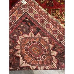 Persian Azerbaijani rug, red ground field with central stylised flower head medallion which repeats in each corner, decorated all over with stylised plant and bird motifs, repeating guarded border with geometric design 