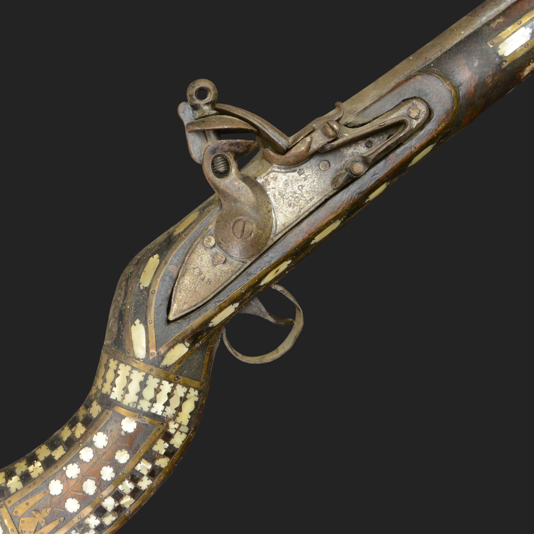 Indian Jezail style flintlock musket, with 118cm barrel, the East India Company lock marked 1818,  the curved butt inlaid with mother of pearl and brass decoration, overall L155cm