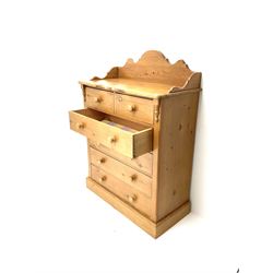Solid pine chest, raised shaped back, two short and four long drawers, plinth base