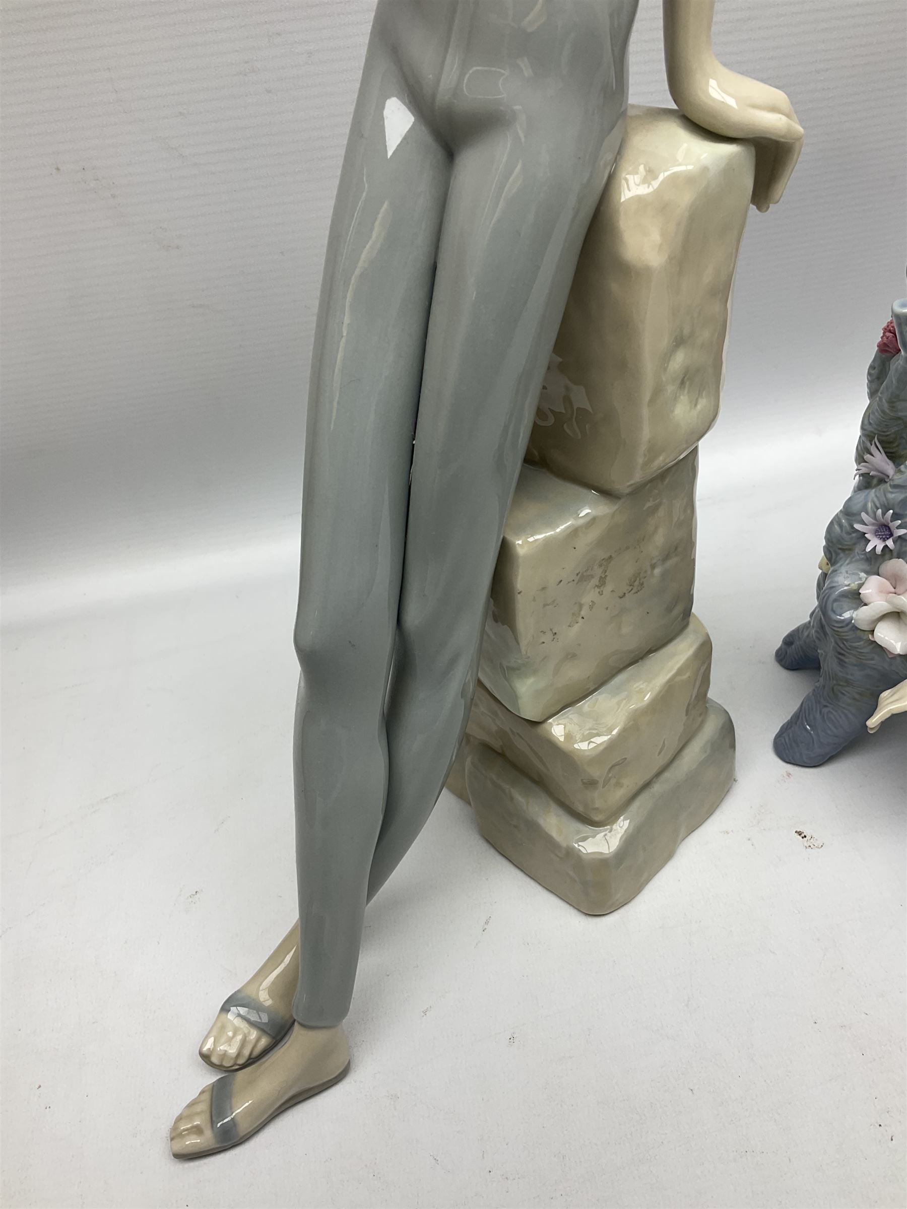 Four Lladro figures, comprising Touch of Class no 5377, Boy Student no 4517, Ocean Beauty no 5785 and Carnival Couple no 4882, largest example H45cm