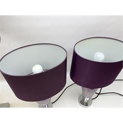 Three lamps, comprising pair with tapered crackled design stems upon chrome bases with purple fabric shades, and a large heavy example with clear glass centre stem with chrome mounts and satin grey shade with gilt interior, H58cm excl shade