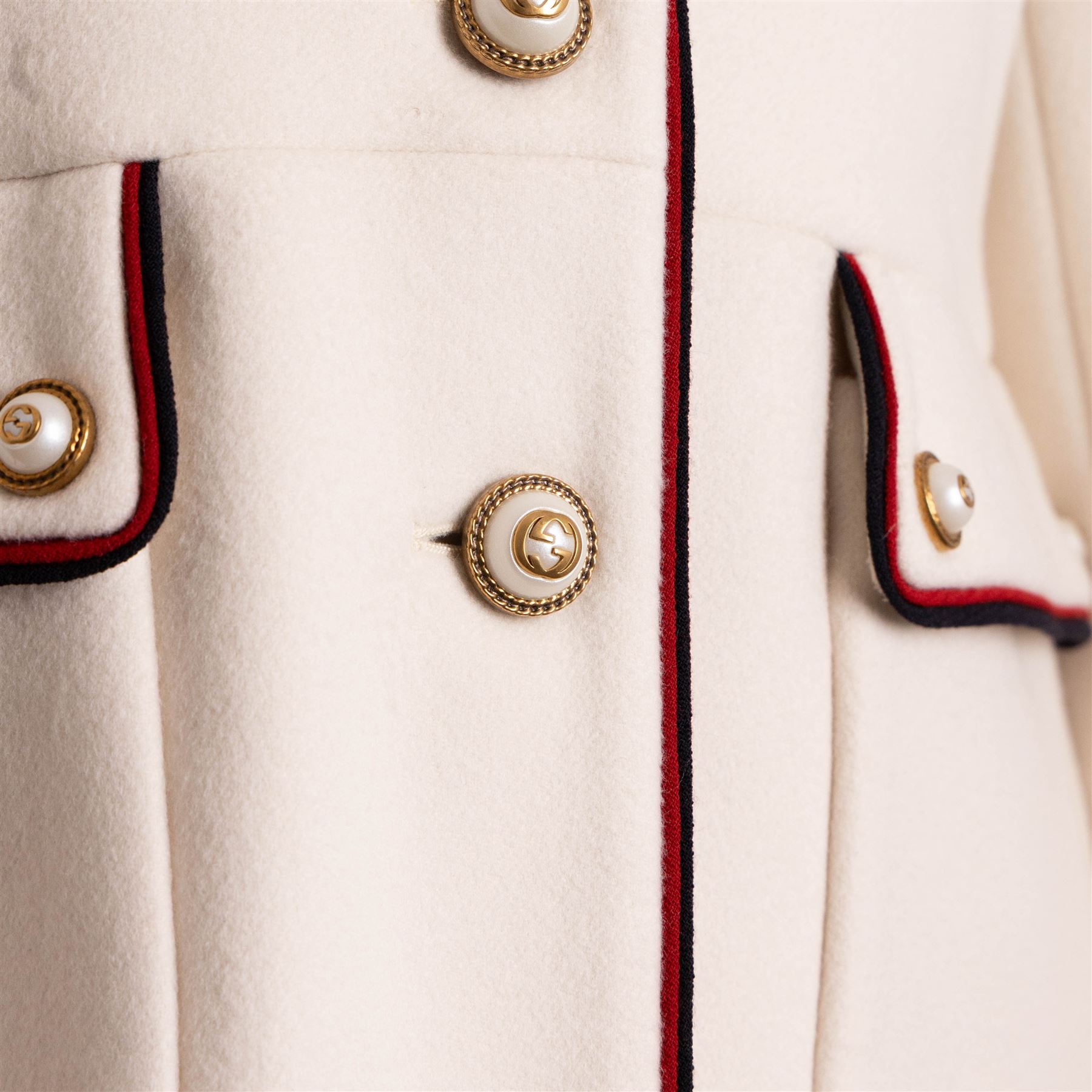 Gucci - bee embroidered wool single-breasted military coat, from the Autumn/Winter 2017 collection under Alessandro Michele, in ivory, with stand collar, red and navy trim, pearlescent and gold-tone button fastening and embroidered bee detailing to the collar, size 14, unused with original garment bag and tags