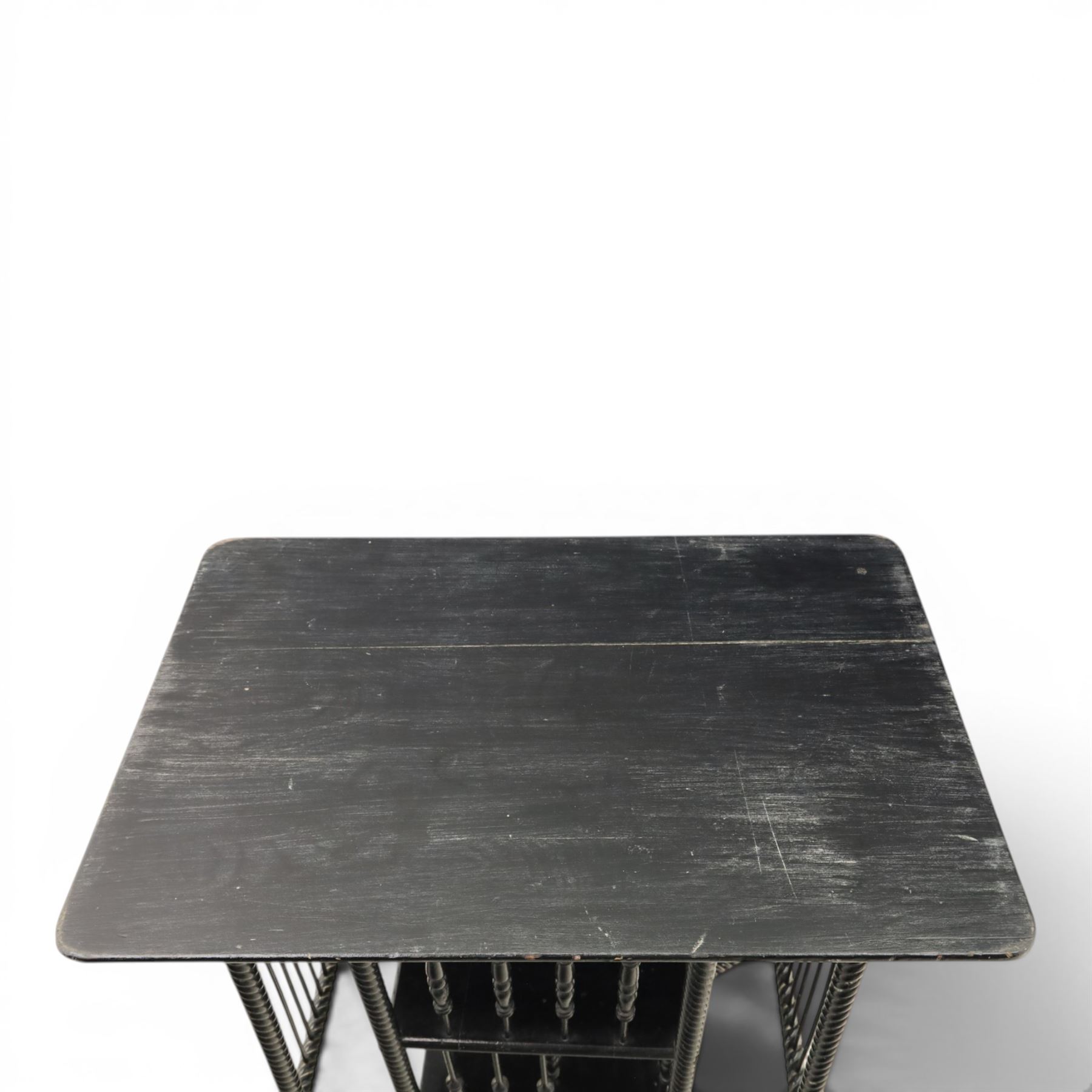 Edwardian black painted side table with incorporated revolving bookcase, supported on barley twist legs