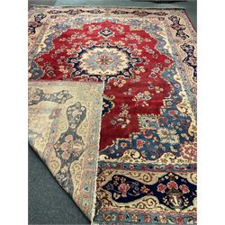 Large Persian red ground rug, central medallion, floral field, repeating boarder