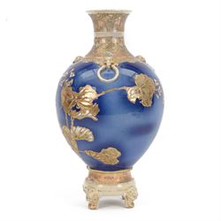 Japanese Satsuma vase, of ovoid form with wasted neck, and three applied mask mounted ring handles, upon four mask detailed feet, the blue ground body painted with blossoming vines, with painted gilt mark beneath, H38cm