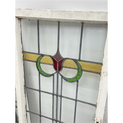 Collection of stained and leaded glass windows and panes, stylised floral design, various sizes, the largest window measuring 55cm x 112cm (including wooden frame)