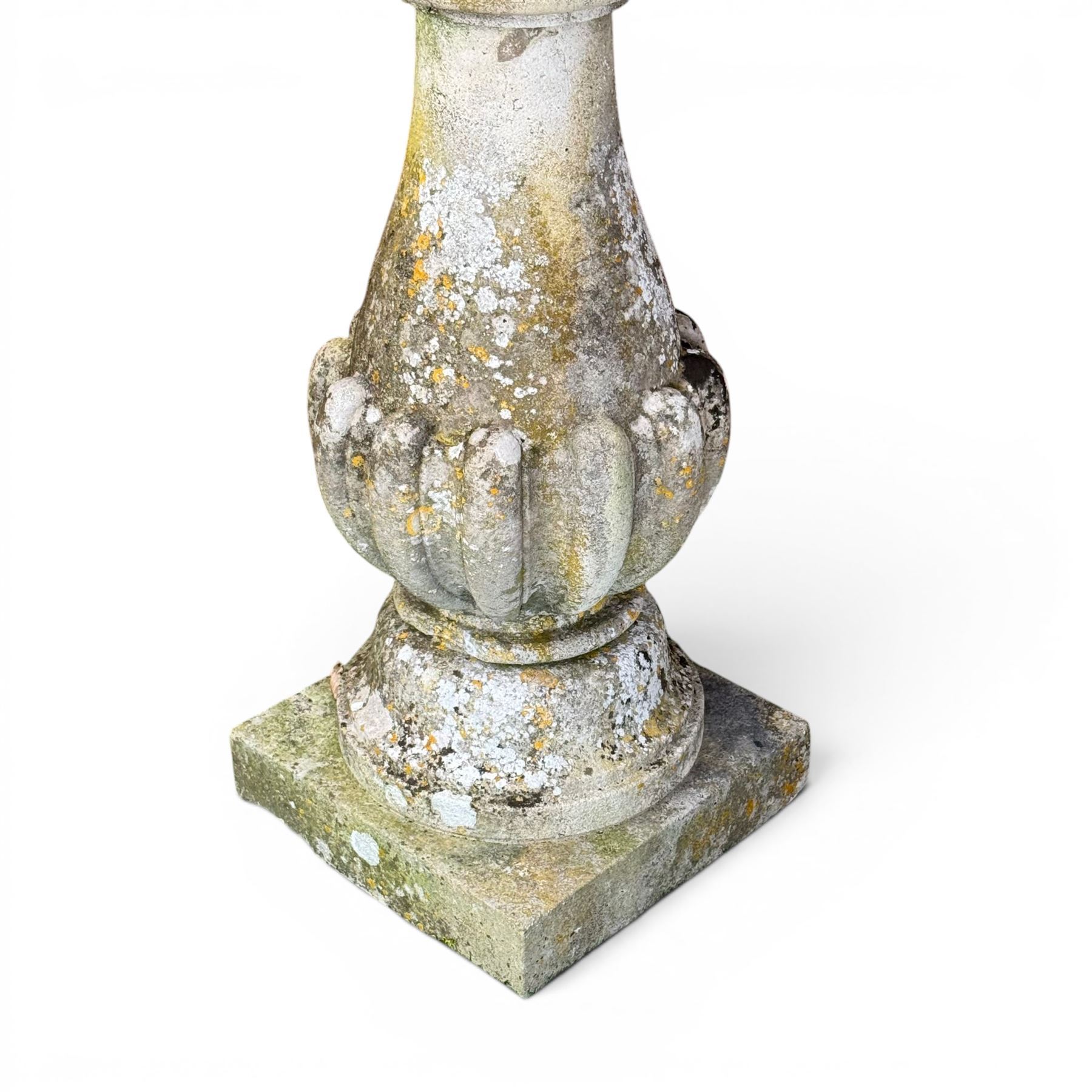 Large weathered cast stone sundial, raised on circular column of bulbous form, square plinth base