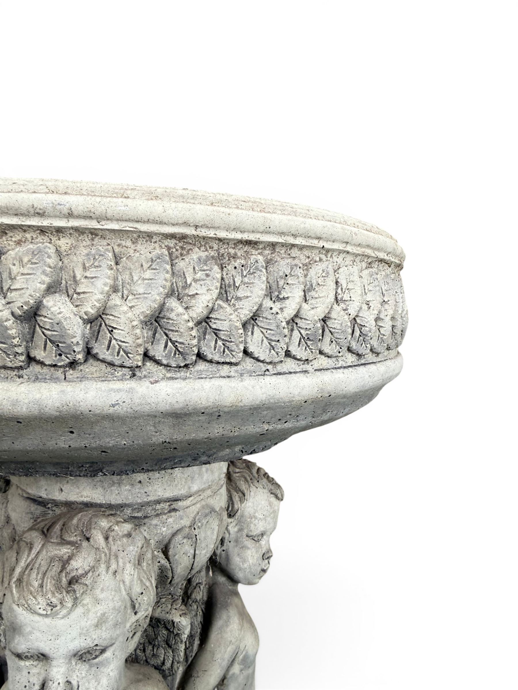Cast stone cherub bird bath, circular removable top raised on three cherubs with ornate detailing
