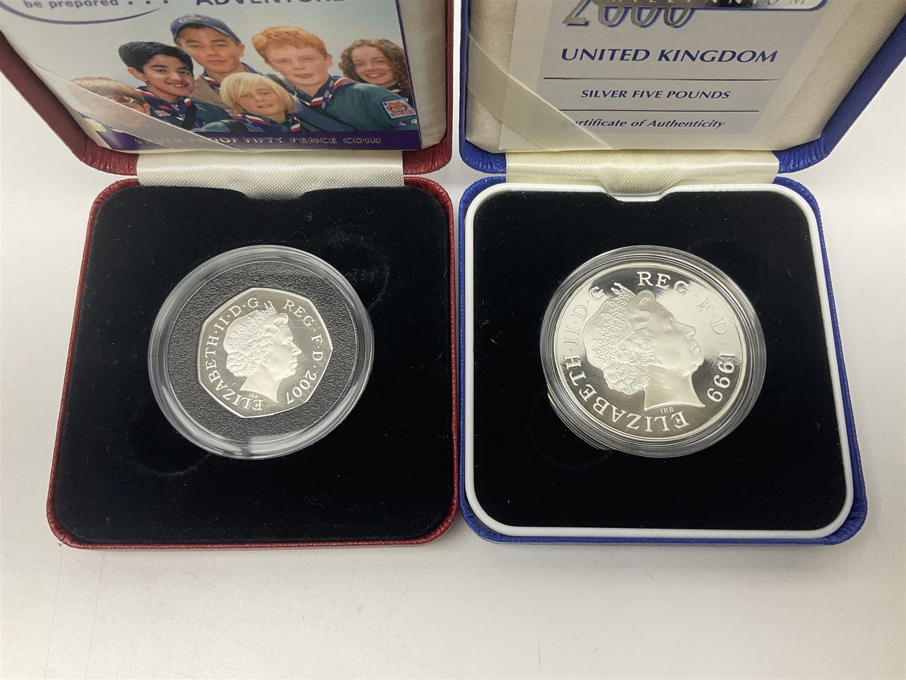 Queen Elizabeth II 2000 'The Queen Mother' silver proof five pound coin, 2000 'Millennium' silver proof five pounds, 2007 'Scouts' silver proof fifty pence, Tristan Da Cunha 2014 9ct gold 1 gram gold one crown coin, all cased with certificates and a 'Prince Charles 60th Birthday Commemorative Coin Cover' containing a 2008 silver proof five pound coin in folder (5)