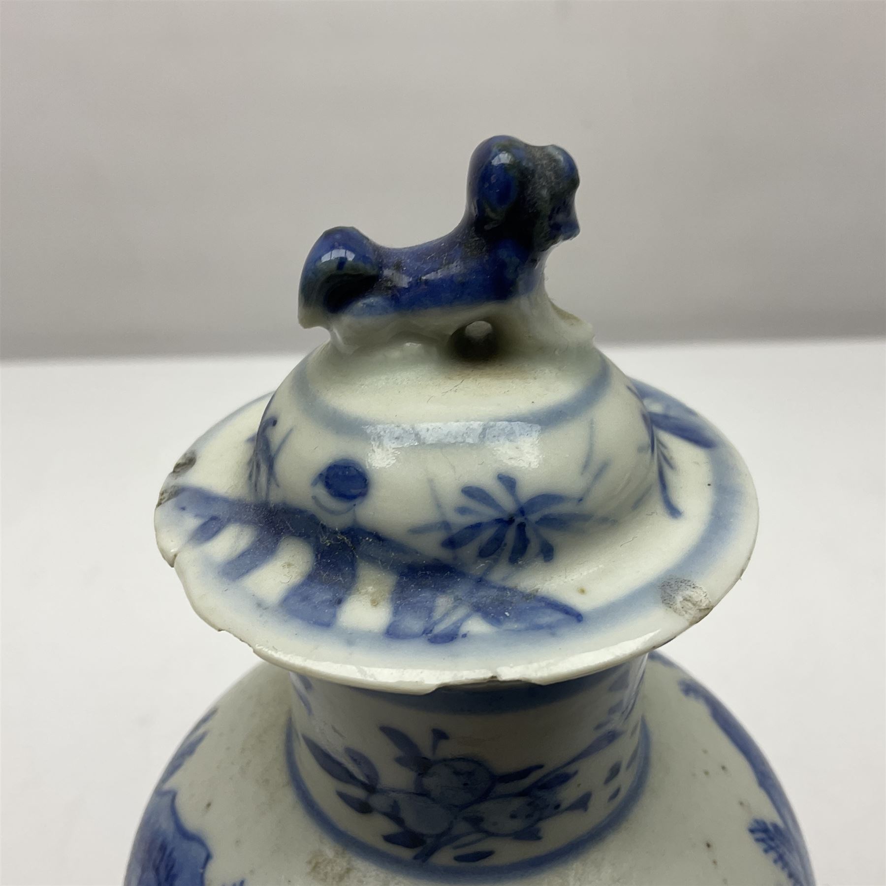 19th century Chinese Kangxi style blue and white jar and cover, decorated with figural and landscape scenes, the domed cover with foo dog finial, with four character marks beneath, H22cm