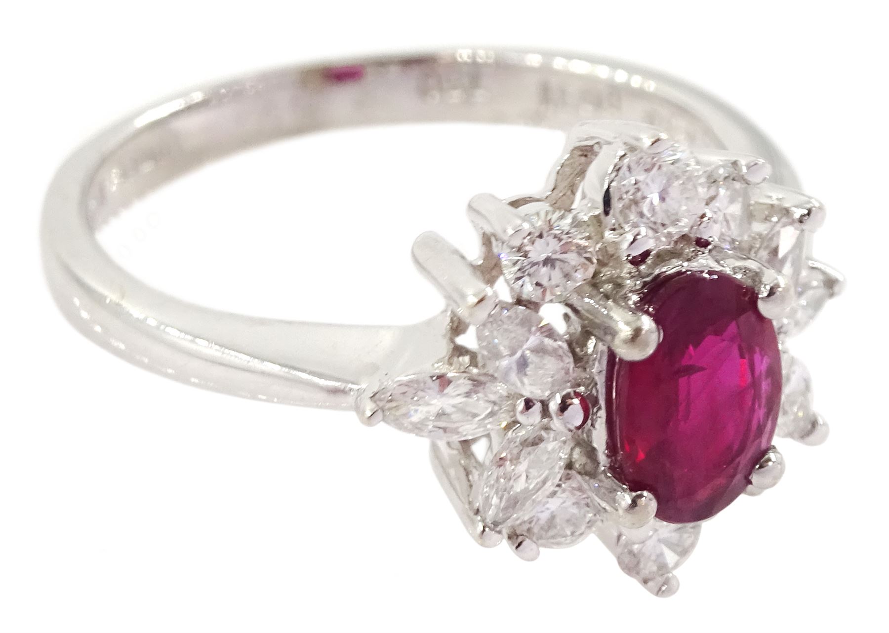 18ct white gold ruby and diamond cluster ring, the oval cut ruby of 0.86 carat, with marquise cut and round brilliant cut diamond surround, London 2004, total diamond weight 0.65 carat 