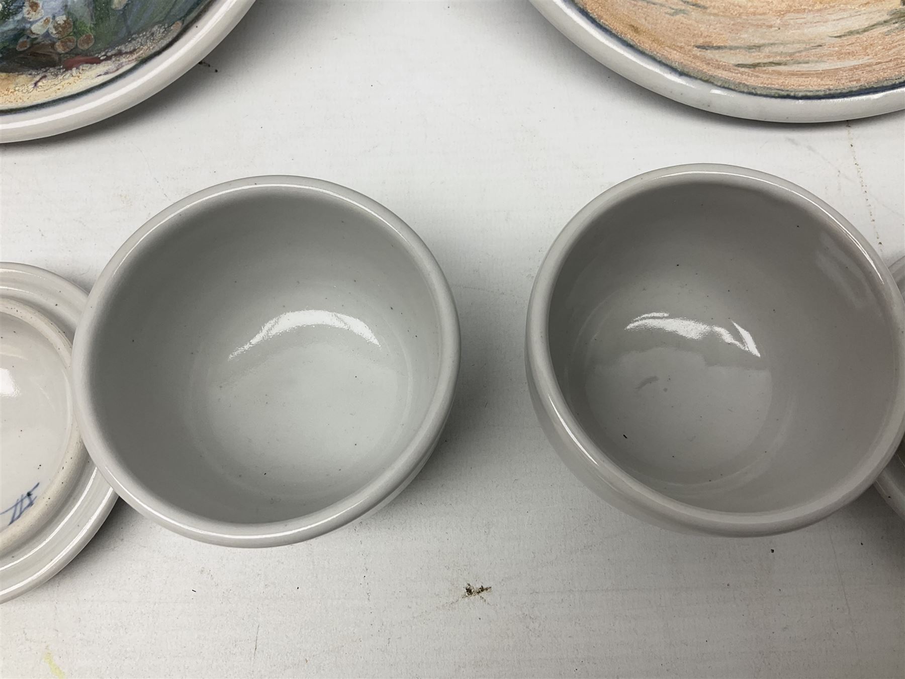 Highland Stoneware Scotland, decorated with landscapes and seascapes, comprising of two bowls, plate and two covered trinket boxes 