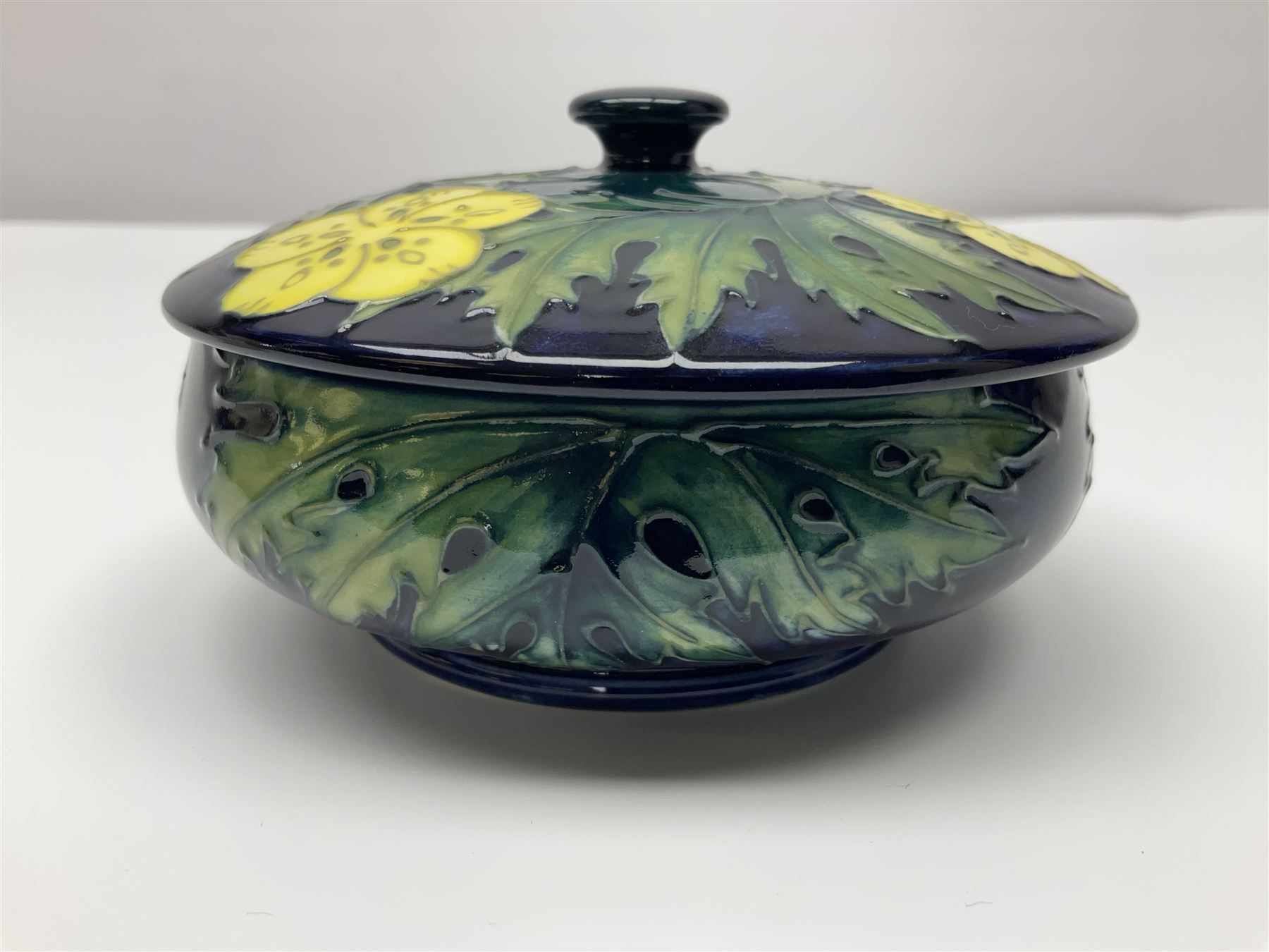 Moorcroft dish and cover, of circular form, decorated in Buttercup pattern, together with a Moorcroft vase, of baluster form, decorated in Magnolia pattern, both with printed marks beneath, tallest H9.5cm