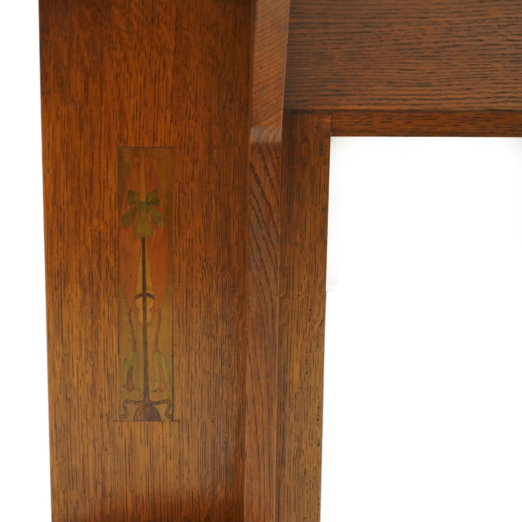 Manner of Liberty & Co, - Arts & Crafts inlaid oak overmantel mirror, the deep-projecting cornice over a rectangular plate, flanked by Art Nouveau marquetry panels of stylised tulip and foliate motifs, over a canted shelf and tulip-pierced upright