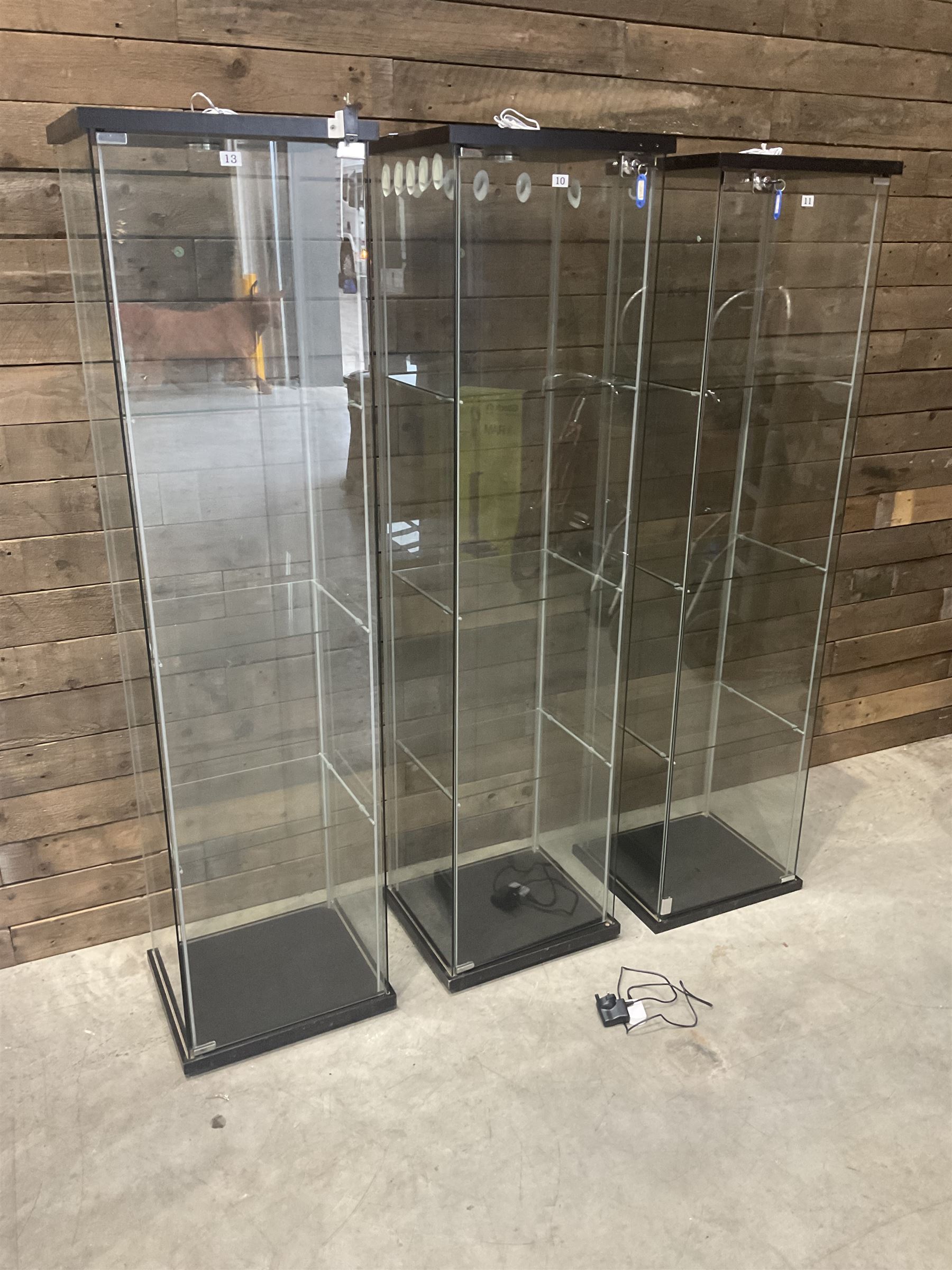 Three Ikea rosewood finish illuminated four glass shop display cabinets, with shelves and keys