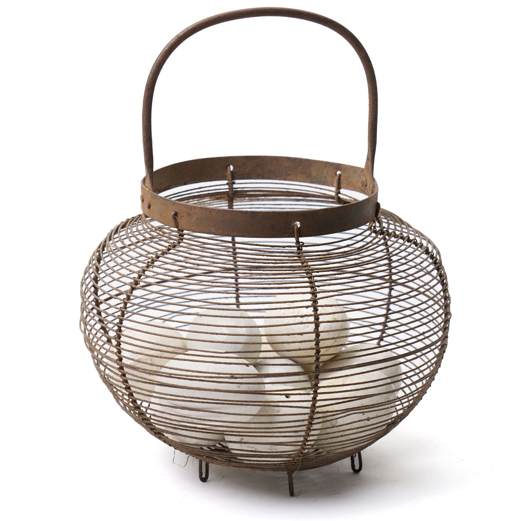 Wire crock containing 11 broody hen ceramic dummy eggs, two marked 'Caperns' 