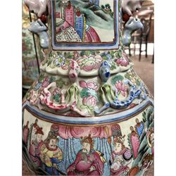 Large pair of 19th century Cantonese famille rose vases, each painted with various courtly scenes, including a display of warriors fighting on horseback before an official and his attendants, double Buddhist lion handles and applied at the shoulders with chilong, the lower band painted with Greek key motif, H58cm (2)
