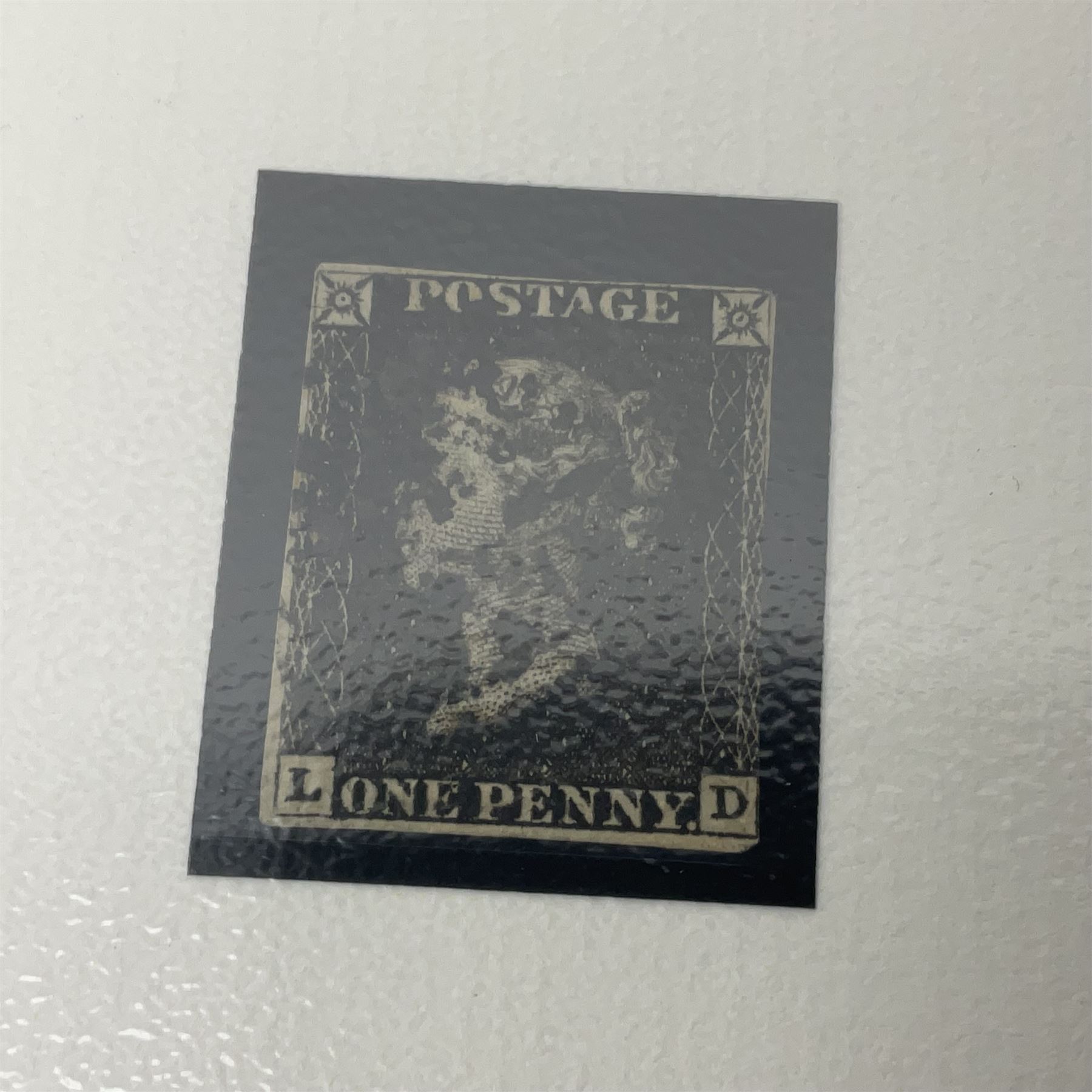 Great Britain Queen Victoria penny black stamp with black MX cancel and 1840 two pence blue stamp with black MX cancel, both housed in folders