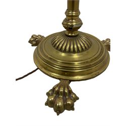 Edwardian brass plated copper standard lamp, telescopic stem on lobe moulded circular base with three projecting paw feet, with cream shade