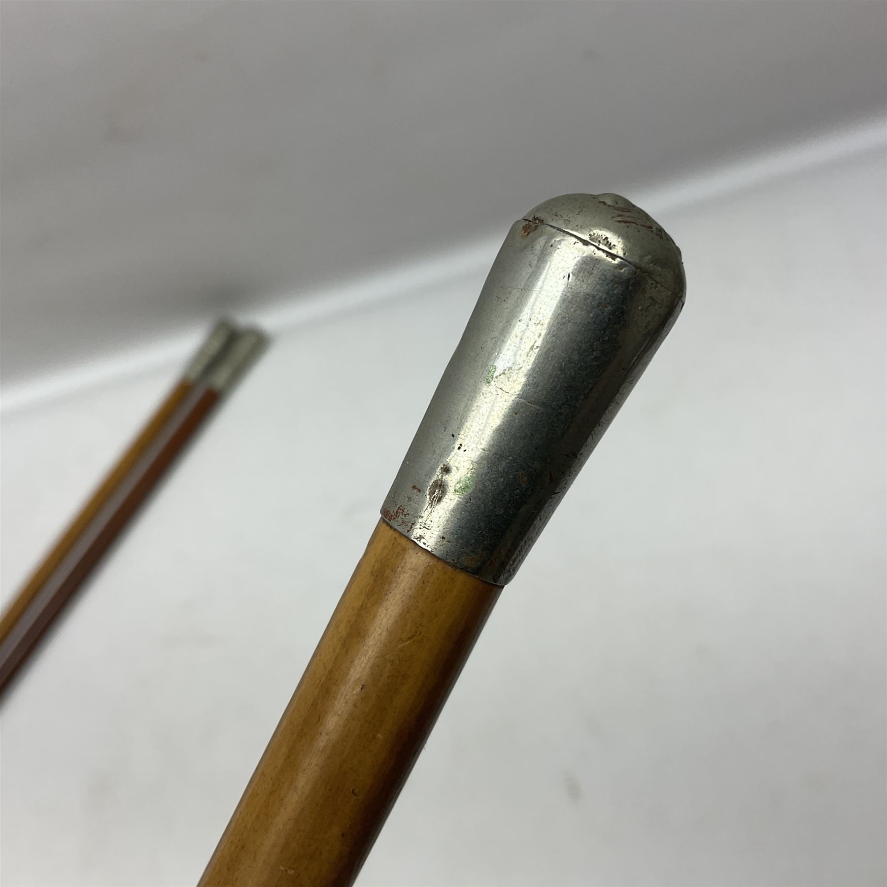 Three malacca cane swagger sticks - Duke of York's Royal military School L68cm; RAMC; and another embossed with a lion to the terminal (3)