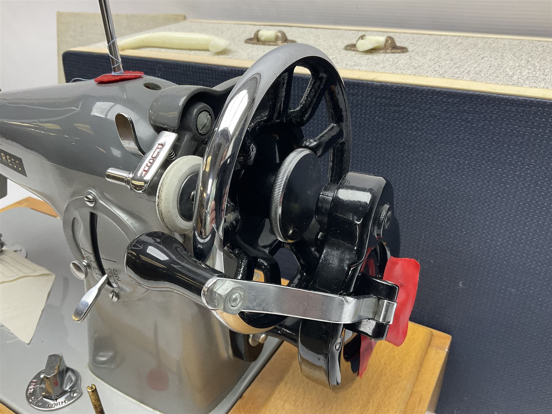 Seamstress sewing machine in case, together with a Singer sewing book