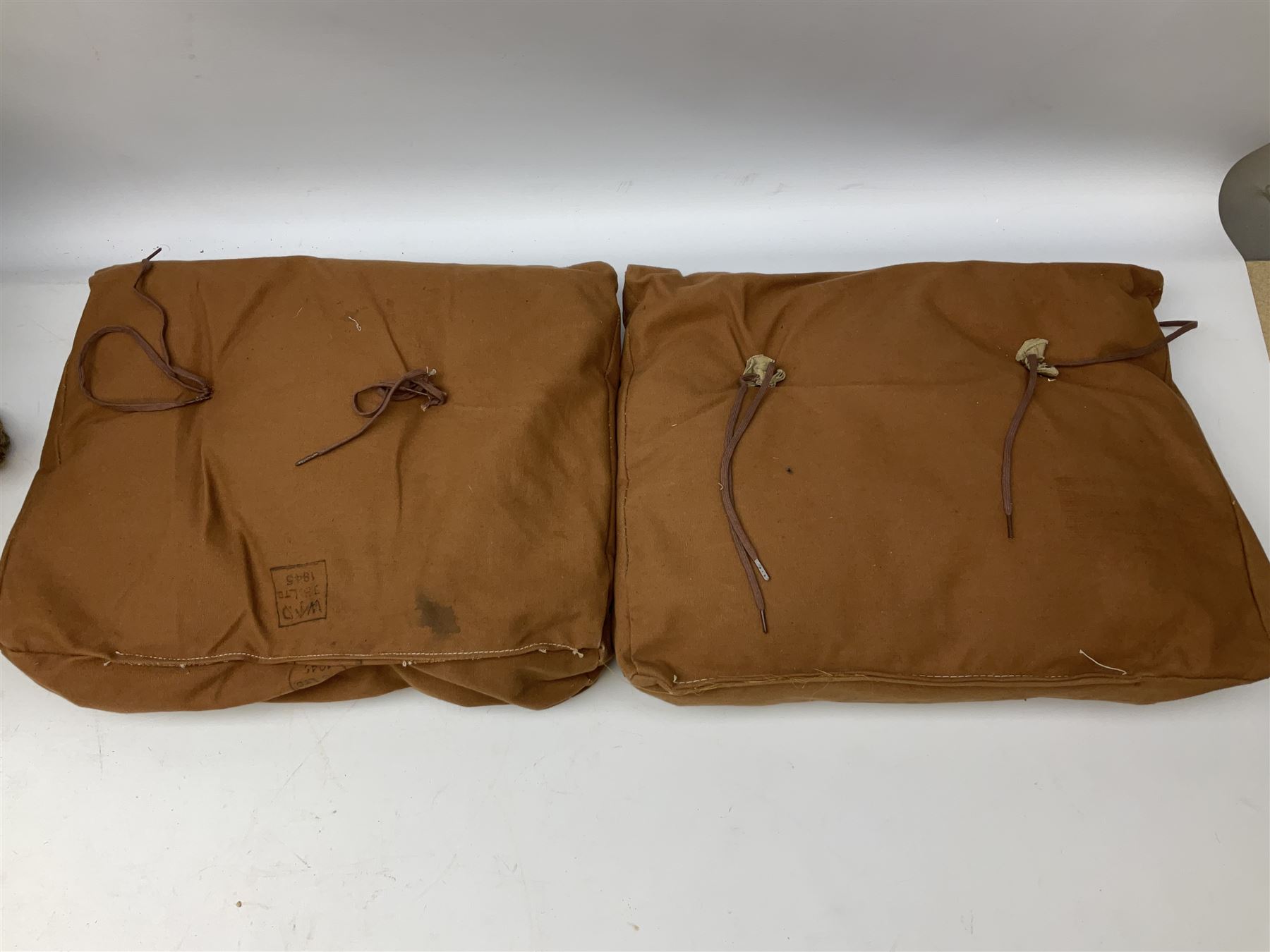 WW2 British Army RAMC 'Regimental Medical Pannier', well marked externally and dated 1941, stamped May 1943 internally, canvas covered wicker form with leather edges, hinged top and fall front with two rope carrying handles, fitted iron locking straps with securing chains; contains various unused field dressings and bandages with WW2 dates and two pillows; original label under lid L79cm