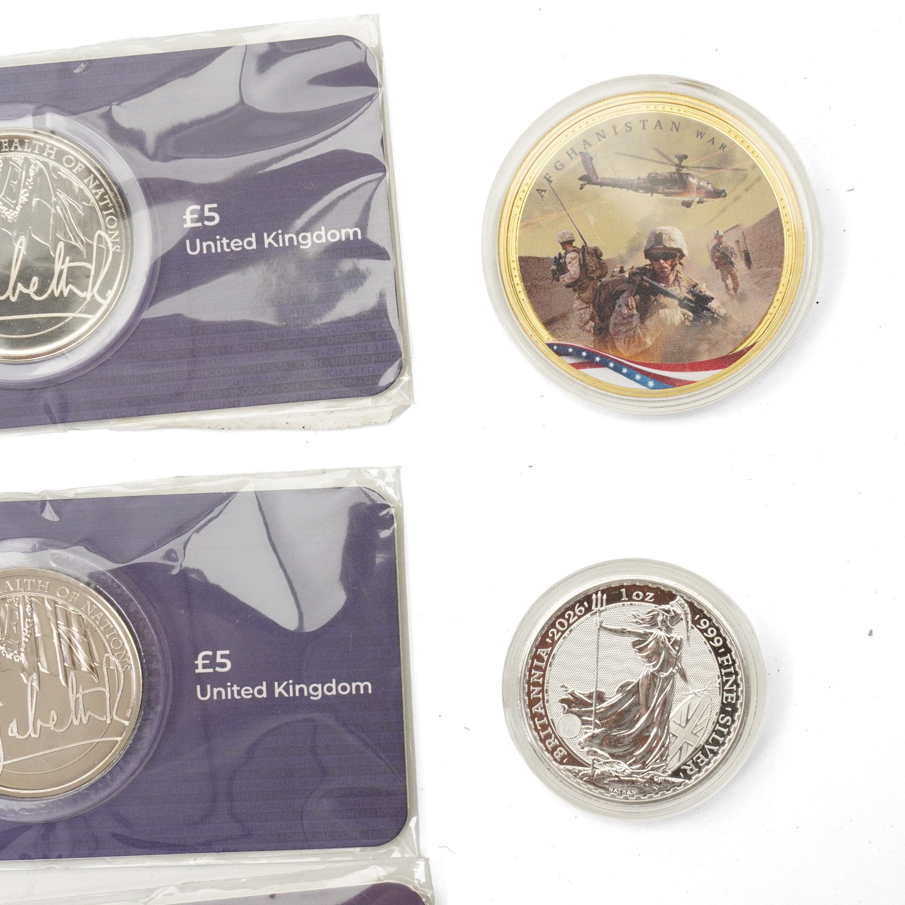 Nine Elizabeth II and Charles III £5 coins, five 50p coins, five Soloman Islands half dollar coins and other coins