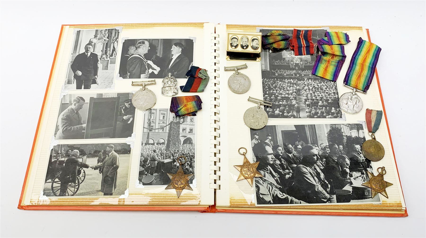 WWI British War medal awarded to 1261 Dvr. T. Paylor R.A., six WWII medals including three stars, WWII souvenir matchbox sleeve, hallmarked silver ARP badge, and an album of photographs and postcards of WWII interest, including Hitler, Montgomery, Churchill, action shots, aircraft, etc. 