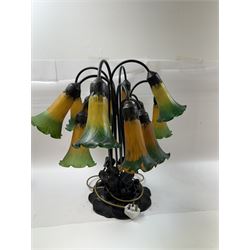 Art Nouveau Tiffany style table lamp, the bronzed base modelled as lily pads leading to tendrils and twelve branches supporting green and yellow glass lily flower shades, H53cm