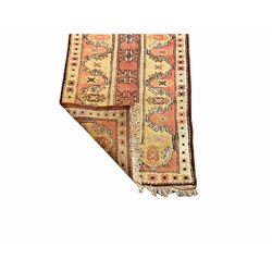 Turkish runner, pale red and yellow ground, the field decorated with stylised star motifs