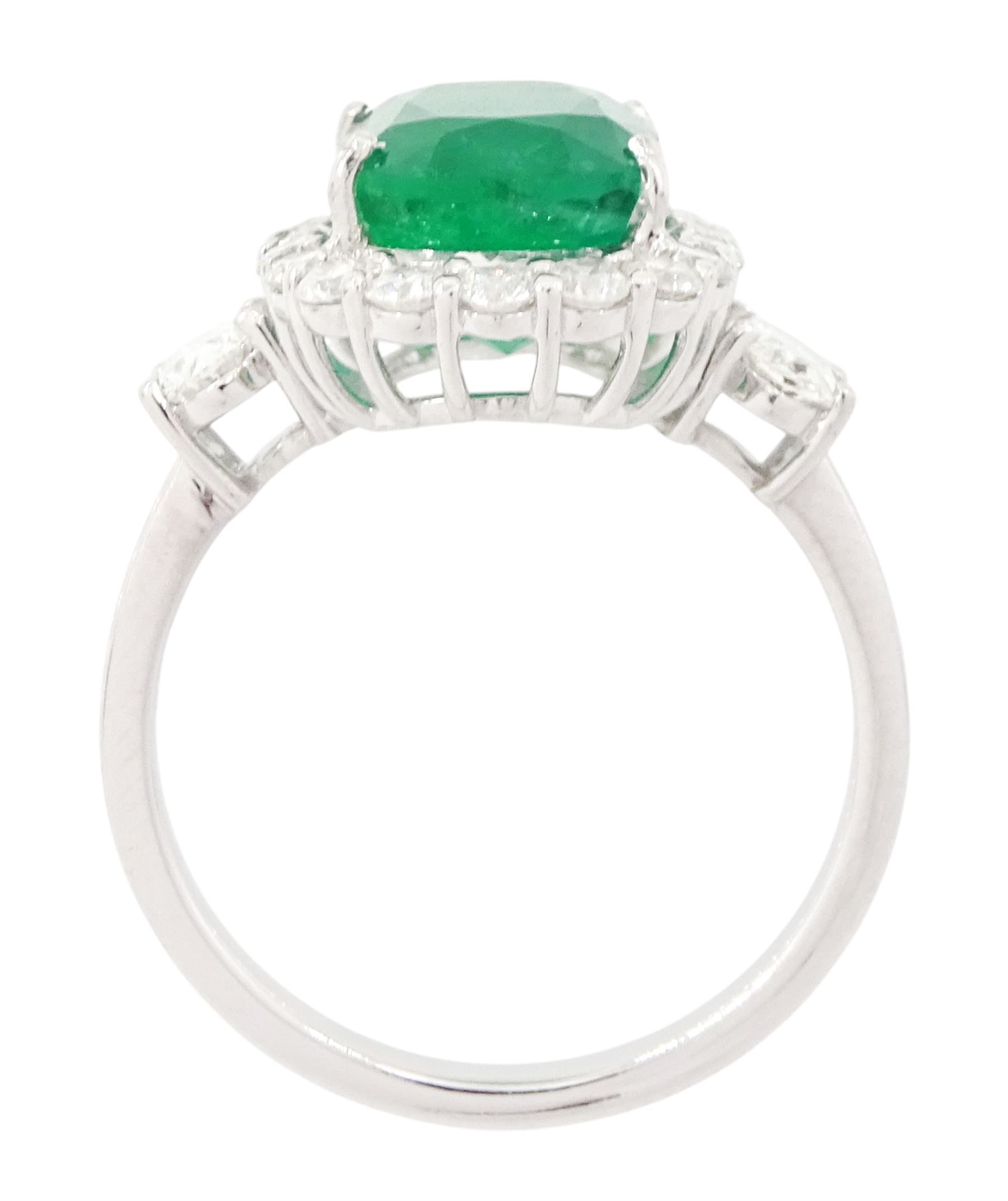 18ct white gold emerald and diamond cluster ring, single cushion cut emerald of approx 2.45 carat, surrounded by eighteen round brilliant cut diamonds, with a single oval cut diamond set either side, stamped, total diamond weight approx 1.05 carat
