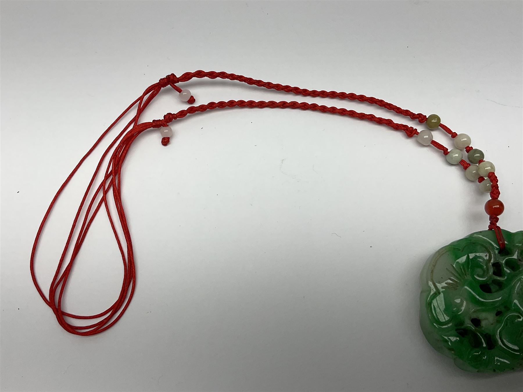 Chinese hardstone carving of a fish amongst coral, with platted rope handle, together with other hardstone and soft stone carvings  