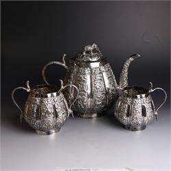 Three piece Indian silver tea service, comprising teapot, twin handled open sucrier and cr...