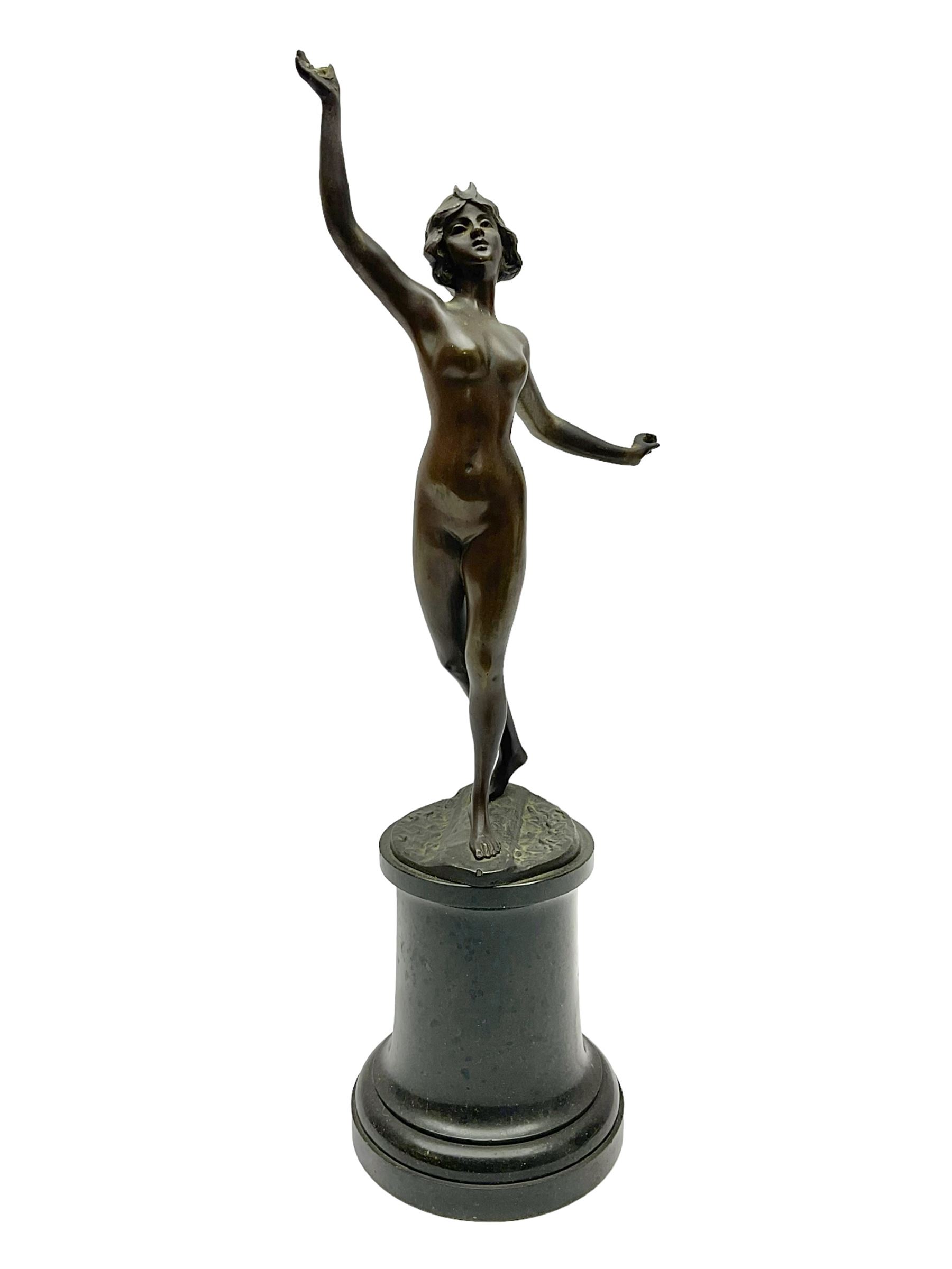 Bronze figure modelled as a nude woman with one arm raised a crescent moon upon her forehead, raised upon a circular stepped plinth, H36cm