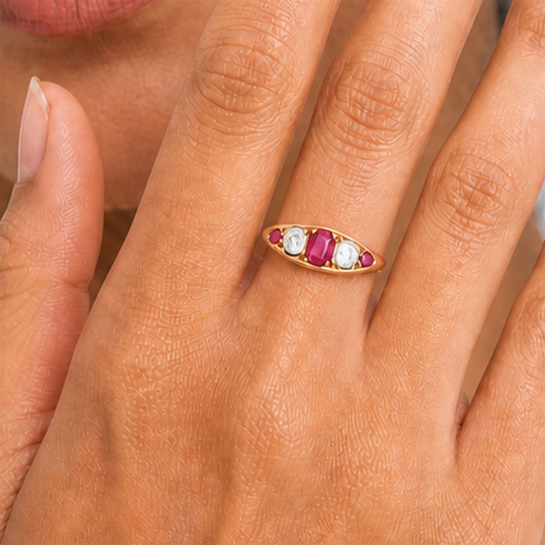 Early 20th century gold ruby and diamond five stone marquise set ring, principal oval cut ruby of approx 0.60 carat, flanked by two old cut diamonds and two round cut rubies, stamped 18ct, total diamond weight approx 0.80 carat