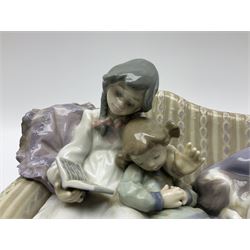 Lladro figure group, Big Sister, modelled as two girls and a puppy seated on a sofa, no 5735, H16cm