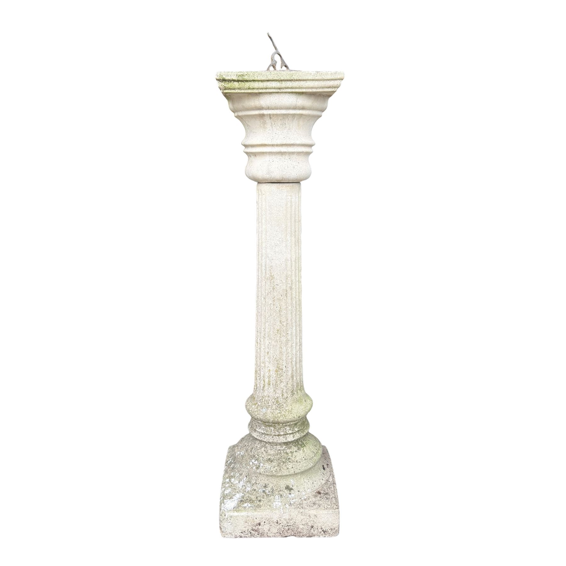 Weathered cast stone sundial on fluted pedestal