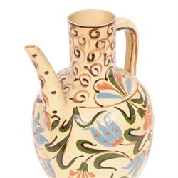 Iznik-style ewer, late 19th/early 20th century, the ovoid body painted with stylized flowers upon a cream ground, the neck with repeating scrolling boarder, H28cm