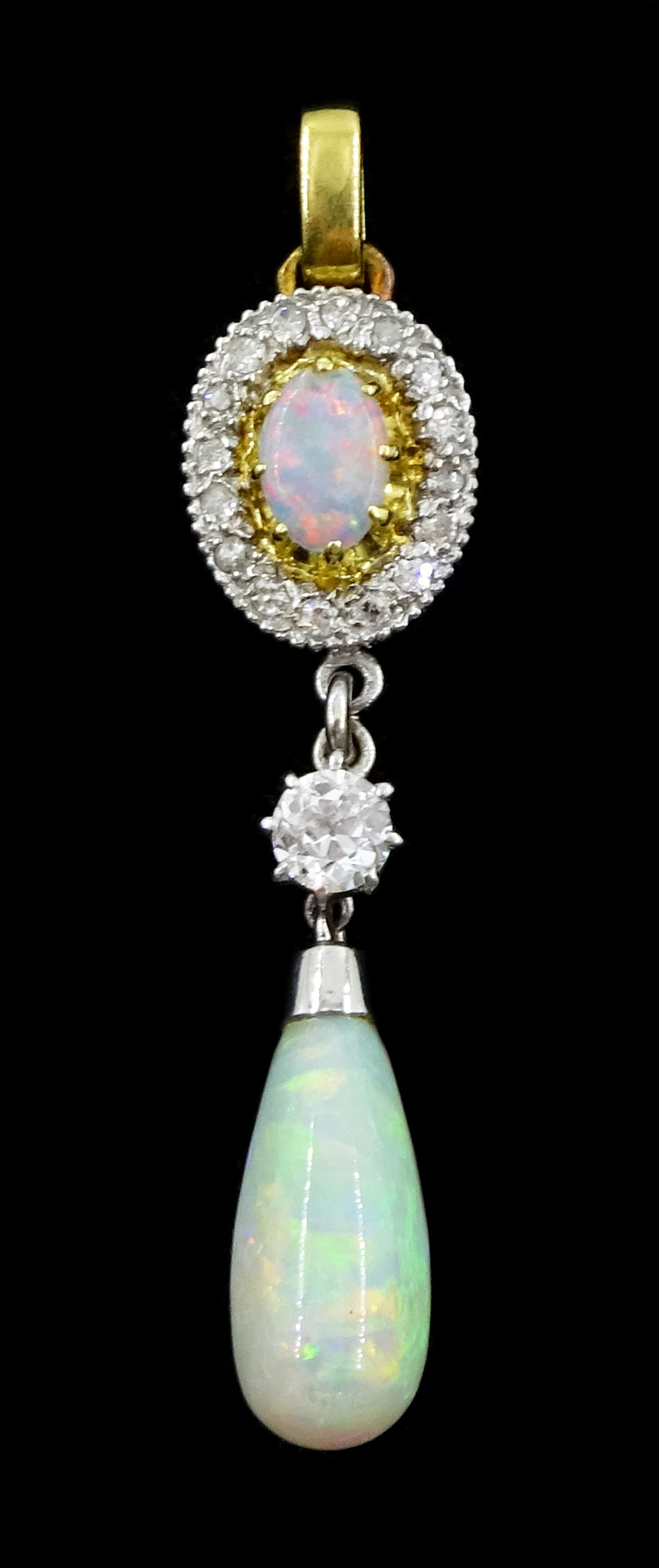 Gold and platinum opal and diamond pendant, the pear shaped opal cabochon suspending from a single old cut diamond of approx 0.20 carat and an opal and diamond cluster