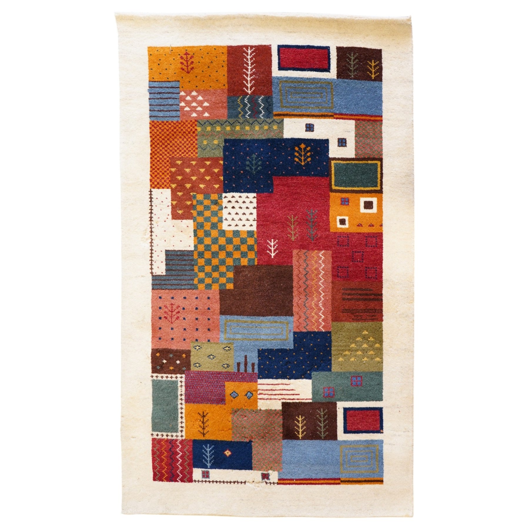 Persian style Gabbeh Loribaft design ivory ground rug, the vibrant field decorated with geometric patchwork design panels with interspersed stylised tree motifs, enclosed by a wide ivory guard band