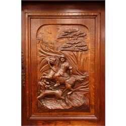  Early 20th century continental carved oak buffet cabinet, raised arched top with carved frieze, enclosed by three carved doors, centre door depicting man on horse back, two drawers with egg and dart detail, double cupboard below, W140cm, H237cm, D52cm  