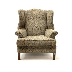 Georgian style wing back sprung armchair, upholstered in stylised patterned fabric, square supports 