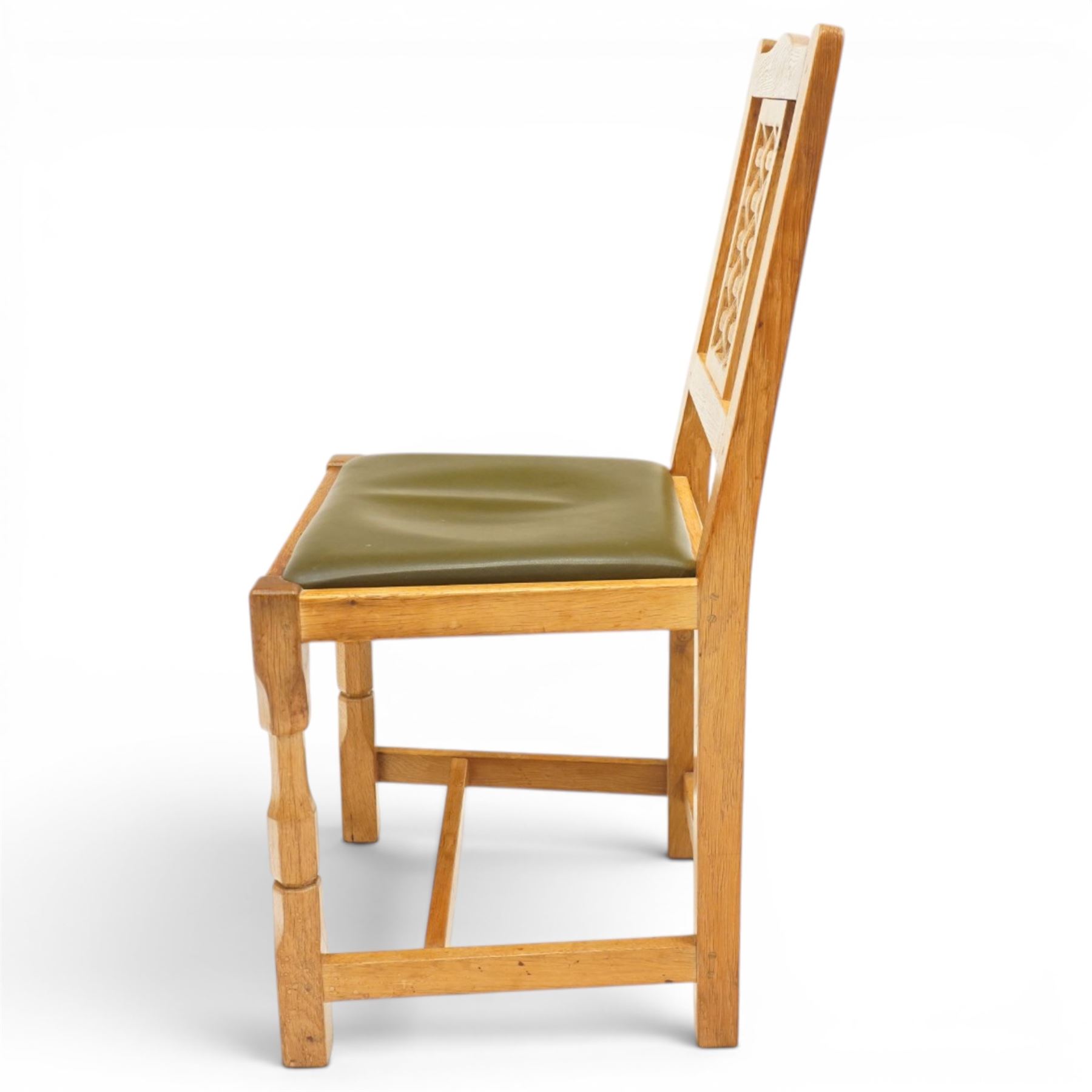 Beaverman - 1980s set of four lattice back dining chairs, shaped top rail above a lattice back, green leather fixed seat, raised on octagonal front supports, with carved Beaver to the back stretcher, by Colin Almack of Sutton near Thirsk