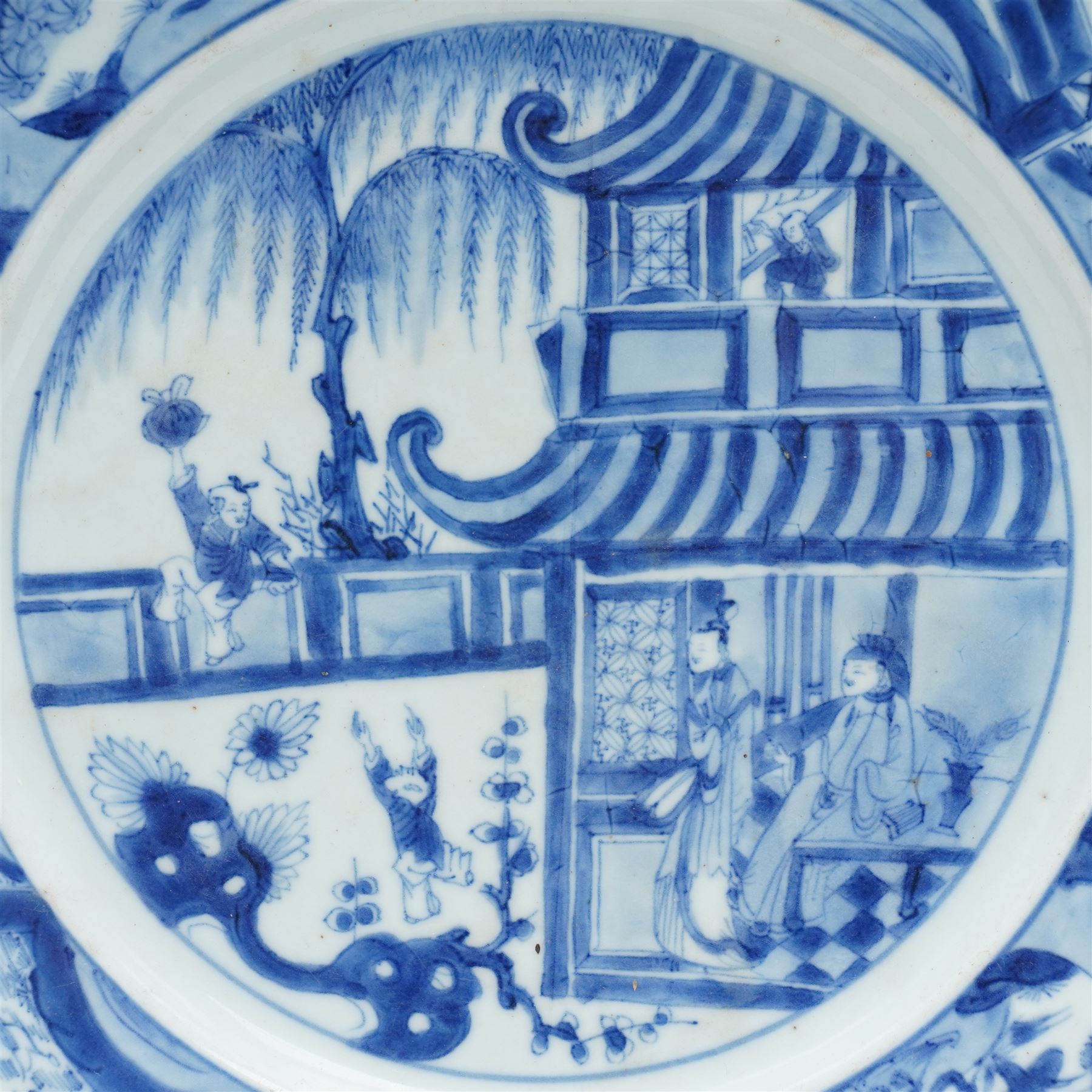 Chinese Kangxi period blue and white plate, decorated with figures in a pavilion, D26cm 
