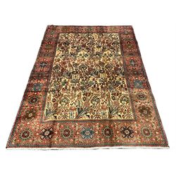 Persian ivory ground rug, the field decorated with stylised plant and bird motifs, the guarded border decorated with flower head motifs