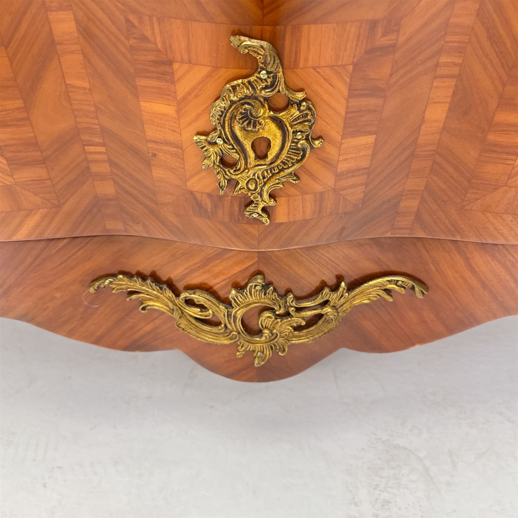 20th century Louis XV design serpentine commode, the rectangular breccia marble top with a rounded moulded edge and projecting corners, above a bombe bombe-shaped kingwood and parquetry design front of two short and two graduated drawers with rococo style handles, corners with gilt-bronze foliate mounts on short cabriole form feet with gilt bronze sabots  