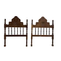Pair Spanish stained beech single 3' bedsteads, spindle turned backs and carved with scrolling floral decoration 