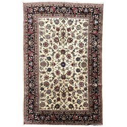 Persian ivory ground rug, the field decorated with interlaced and scrolling foliate with palmettes, the dark indigo border with stylised plant motifs surrounded by scrolled branches